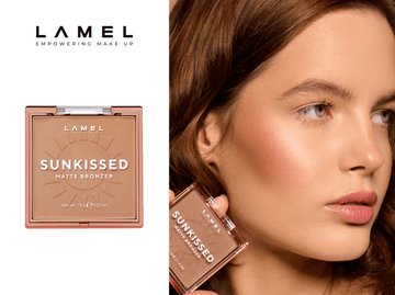 A beauty expert applies bronzer to a woman's face with a fluffy brush